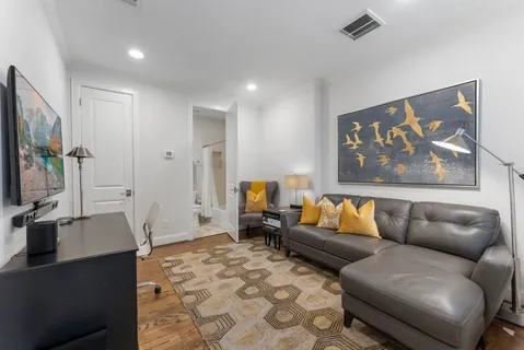a bathroom with a granite countertop sink toilet and mirror