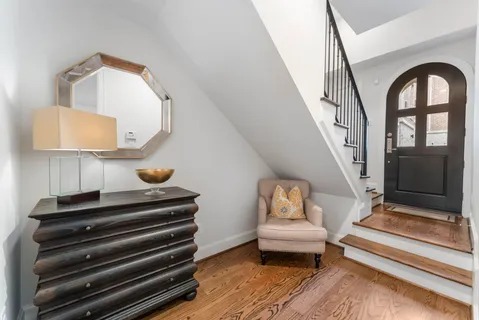 a view of entryway and hall with wooden floor