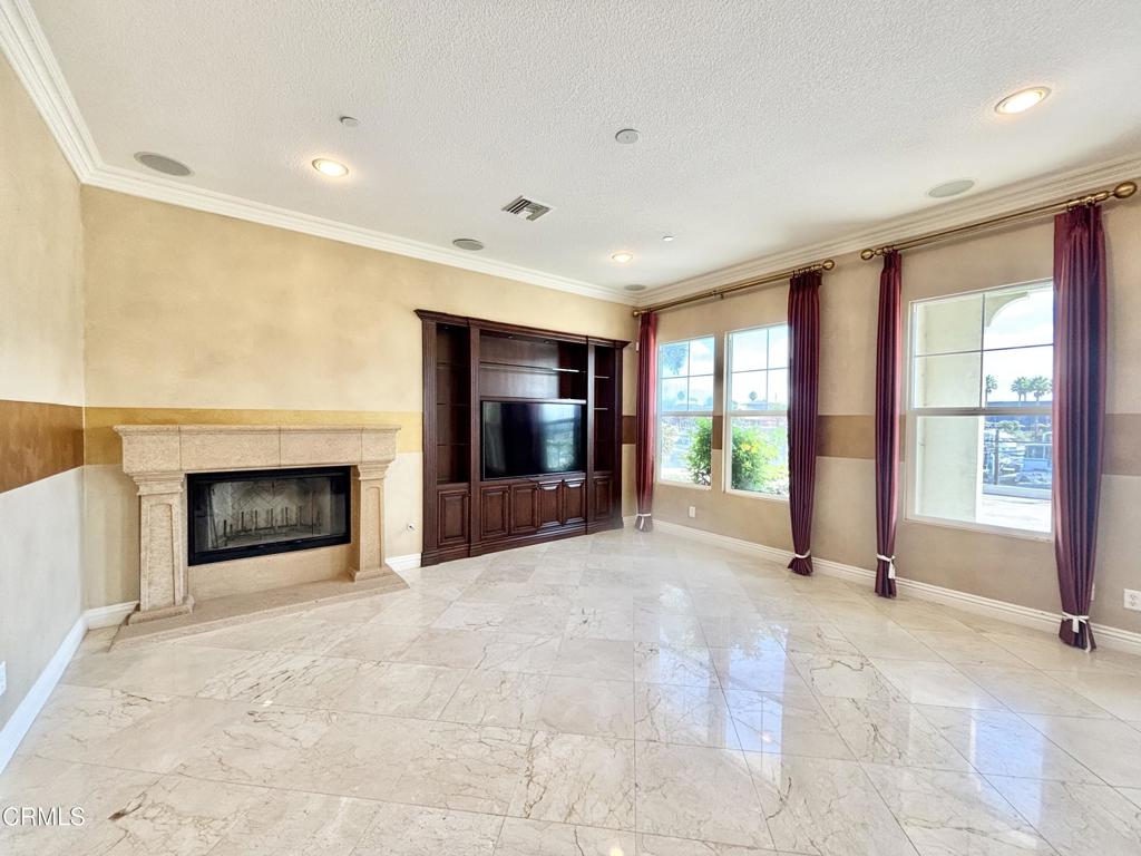 1702 Aleutian Way Oxnard, CA 93035 - Photo 18 of 73 a view of an empty room with a fireplace and a large window
