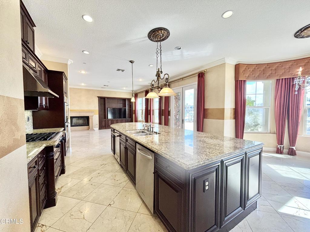1702 Aleutian Way Oxnard, CA 93035 - Photo 23 of 73 a kitchen with stainless steel appliances granite countertop a stove and more cabinets
