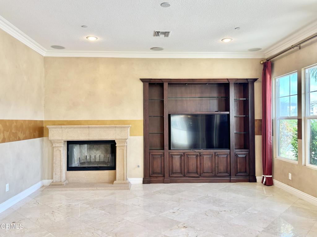 1702 Aleutian Way Oxnard, CA 93035 - Photo 24 of 73 a living room with a fireplace and a flat screen tv