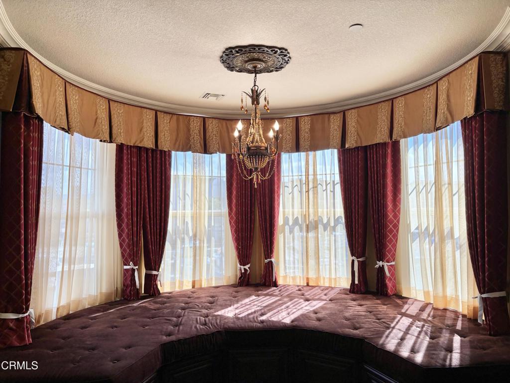 1702 Aleutian Way Oxnard, CA 93035 - Photo 38 of 73 a bedroom with a bed and a chandelier