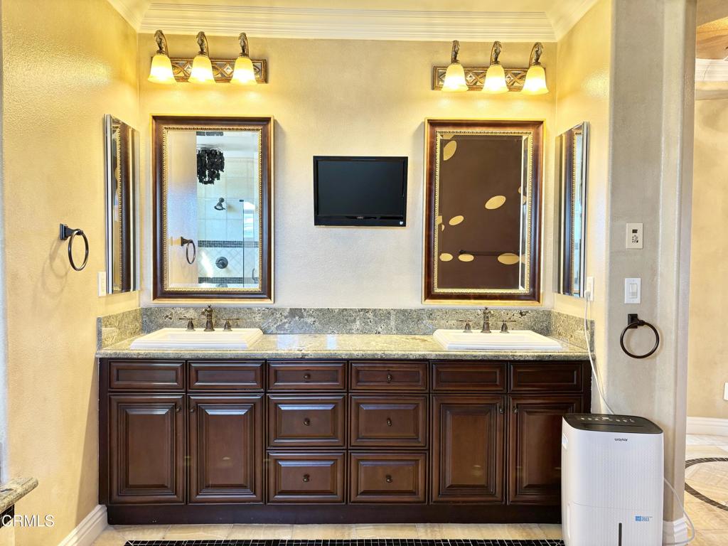 1702 Aleutian Way Oxnard, CA 93035 - Photo 44 of 73 a bathroom with a granite countertop sink vanity and mirror