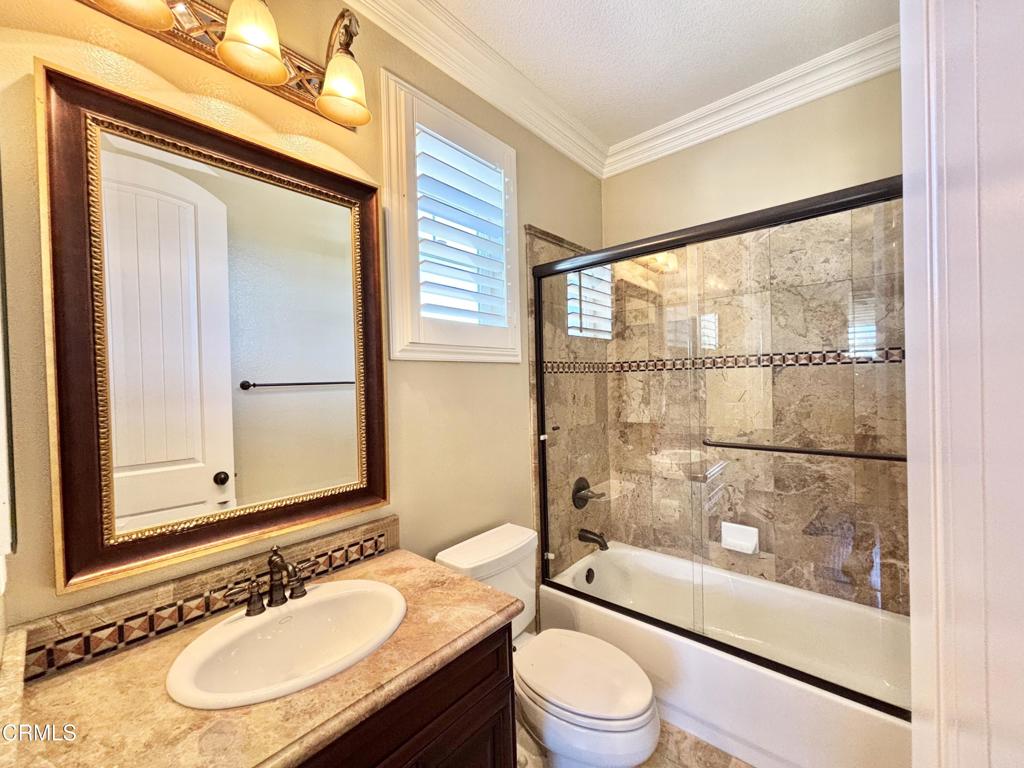 1702 Aleutian Way Oxnard, CA 93035 - Photo 51 of 73 a bathroom with a granite countertop sink toilet a mirror and shower