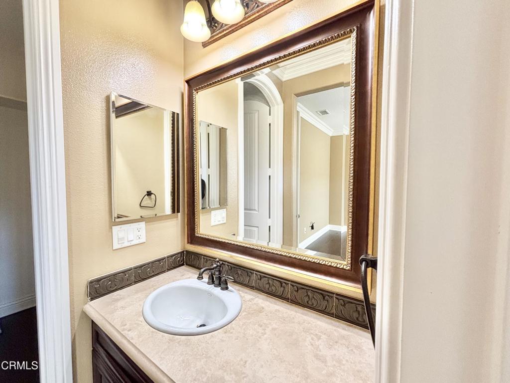 1702 Aleutian Way Oxnard, CA 93035 - Photo 55 of 73 a bathroom with a granite countertop sink and a mirror
