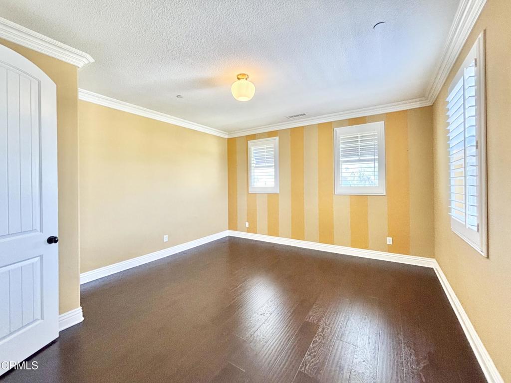 1702 Aleutian Way Oxnard, CA 93035 - Photo 57 of 73 a view of an empty room with wooden floor and a window