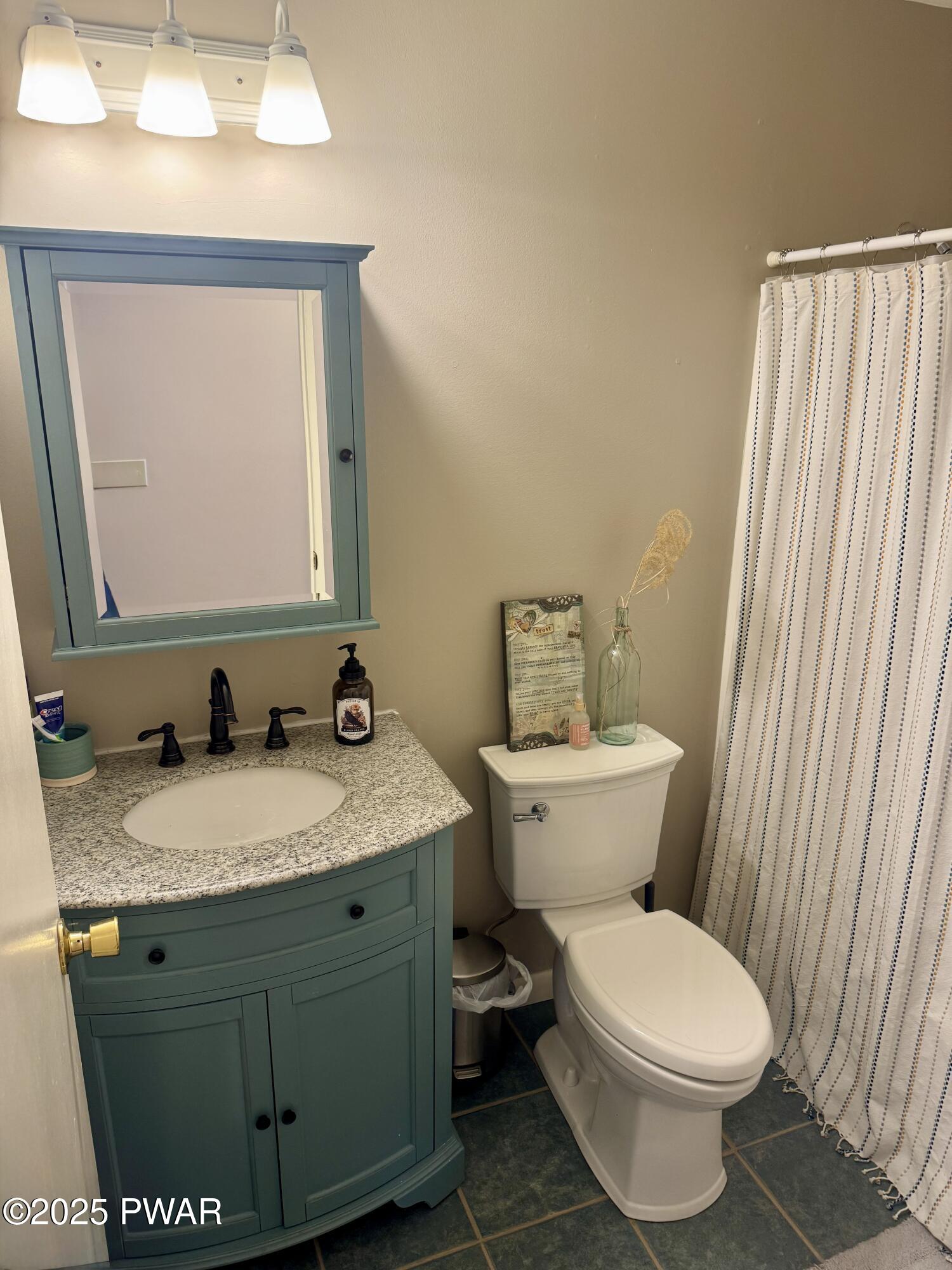 360 South Baker Road Waymart, PA 18472 - Photo 16 of 35 a bathroom with a granite countertop toilet sink and mirror