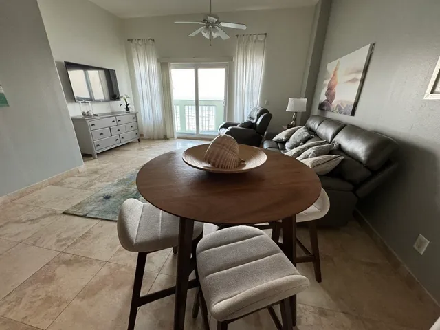 a kitchen with stainless steel appliances granite countertop a table and chairs in it
