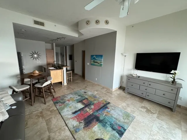 a living room with furniture a dining table and a piano table
