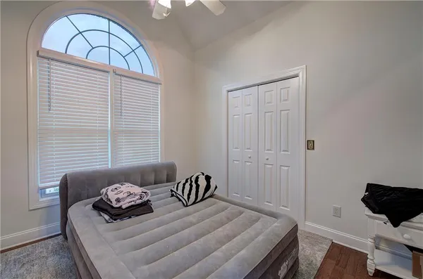 a bedroom with a bed and wooden floor