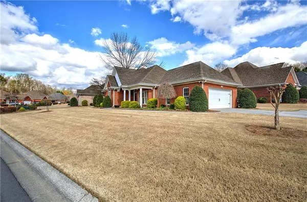 a front view of a house with a yard
