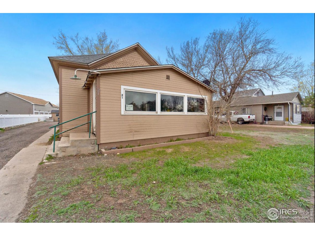 21 Main Street Windsor, CO 80550 - Photo 2 of 12 a view of a yard in front of a house with large tree