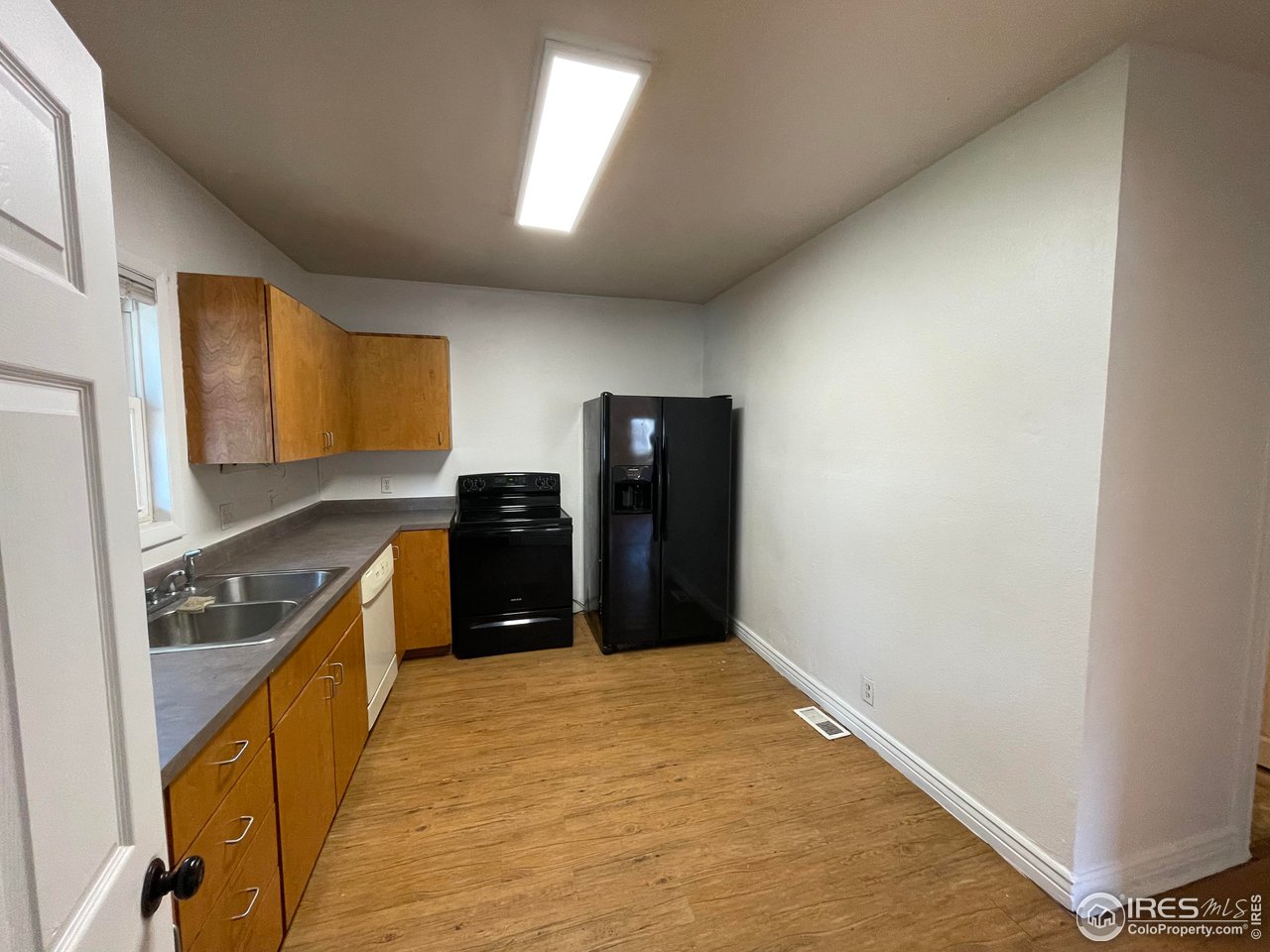 21 Main Street Windsor, CO 80550 - Photo 6 of 12 a kitchen with granite countertop cabinets and refrigerator