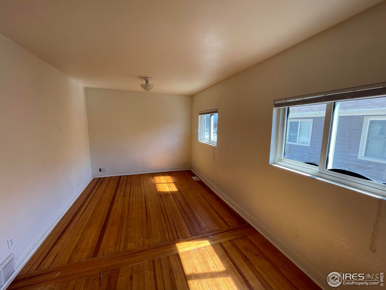 21 Main Street Windsor, CO 80550 - Photo 7 of 12 a view of a room with wooden floor and window