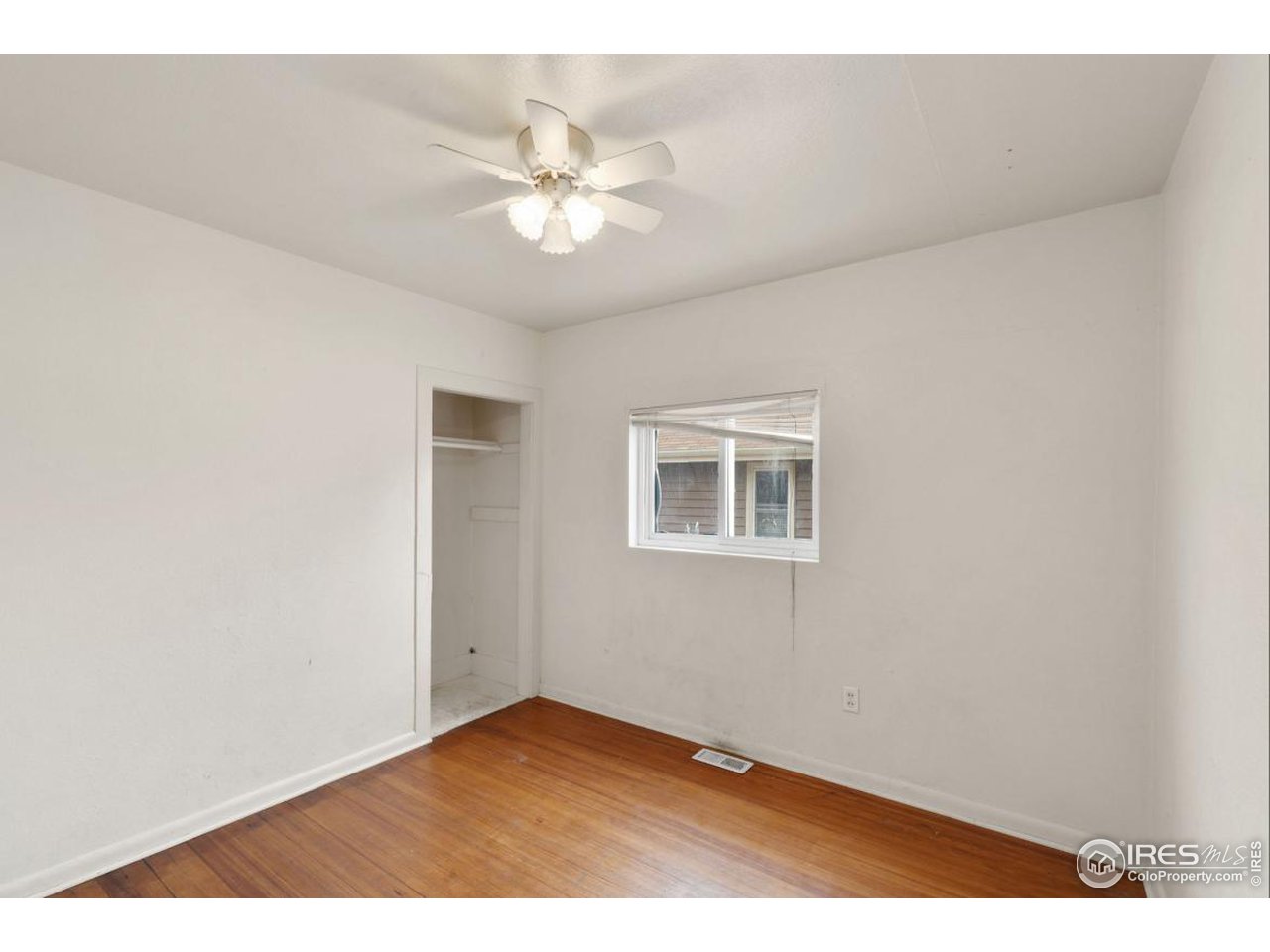 21 Main Street Windsor, CO 80550 - Photo 8 of 12 a view of an empty room with a window
