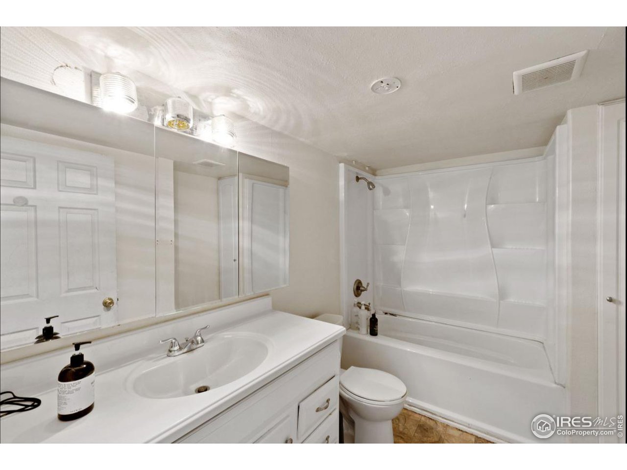 21 Main Street Windsor, CO 80550 - Photo 9 of 12 a bathroom with a sink a toilet and shower