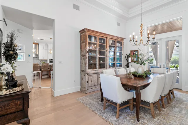 a dining room with furniture and chandelier