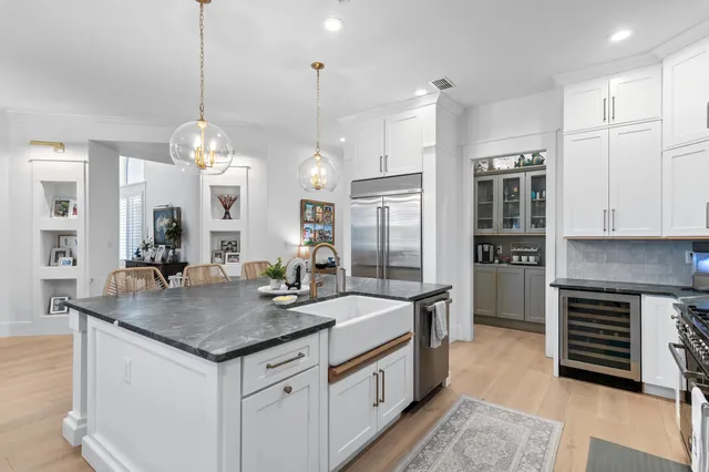 a kitchen with stainless steel appliances granite countertop a kitchen island a stove and a sink