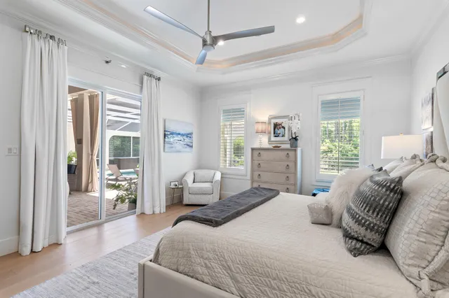 a bedroom with a large bed and windows