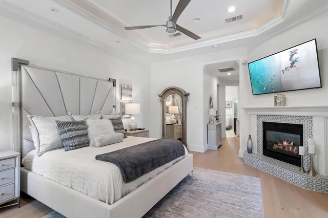 a bedroom with a large bed and a fireplace