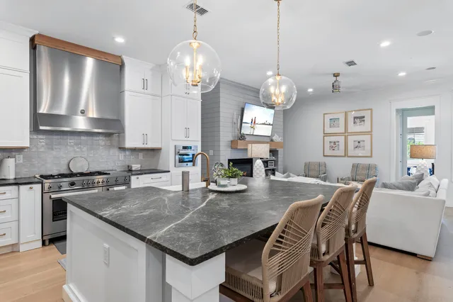 a view of kitchen and dining area with a sink wooden floor