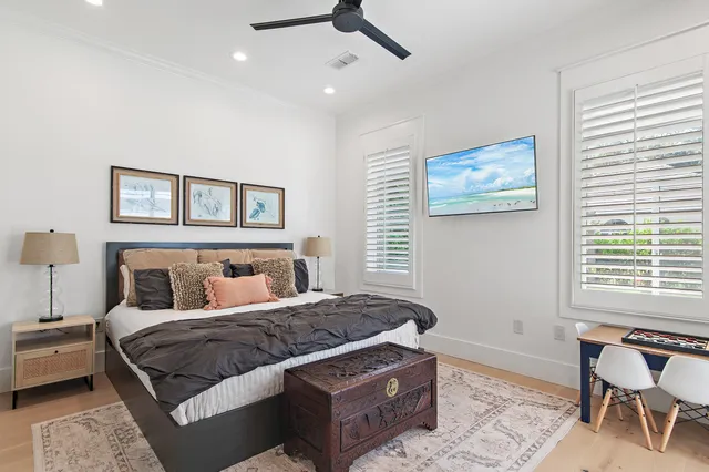 a bedroom with a large bed and a chair