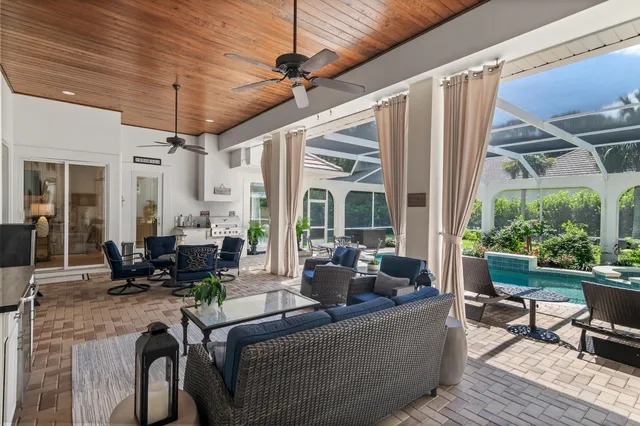 a living room with furniture ceiling fan and a window