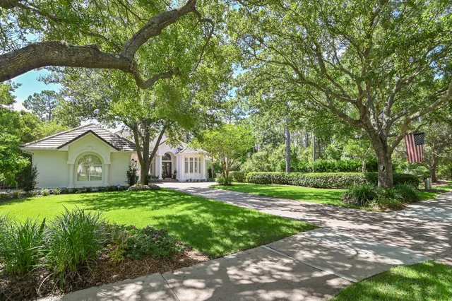 an aerial view of a house with a yard and outdoor seating