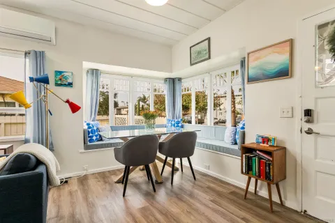 a dining room with furniture and wooden floor