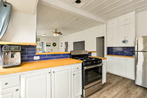 a kitchen with stainless steel appliances a stove and a refrigerator