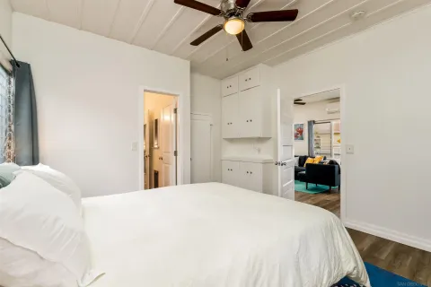 a bedroom with a bed and a chandelier