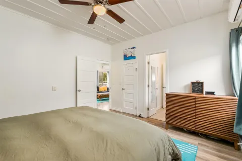 a bedroom with a bed and a chandelier