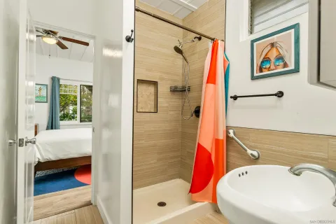 a bathroom with a white bath tub and shower