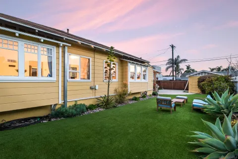 a front view of a house with a garden and sitting area