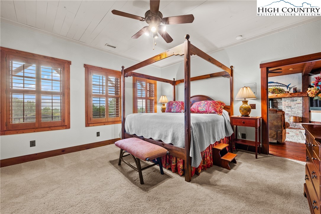 333 Windy Ridge Road Vilas, NC 28692 - Photo 36 of 46 a bedroom with furniture and a window