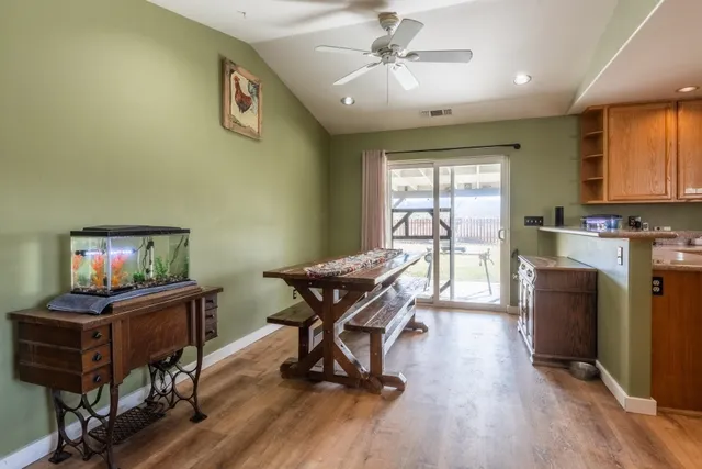 a kitchen with stainless steel appliances granite countertop a stove top oven a sink and a refrigerator