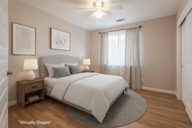 a bedroom with a bed and wooden floor