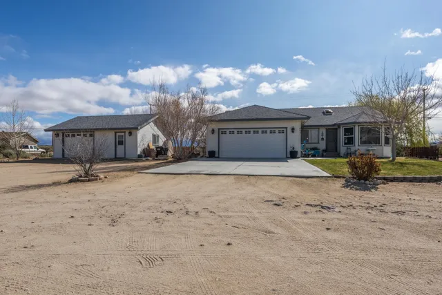 a view of a house with a snow in the background