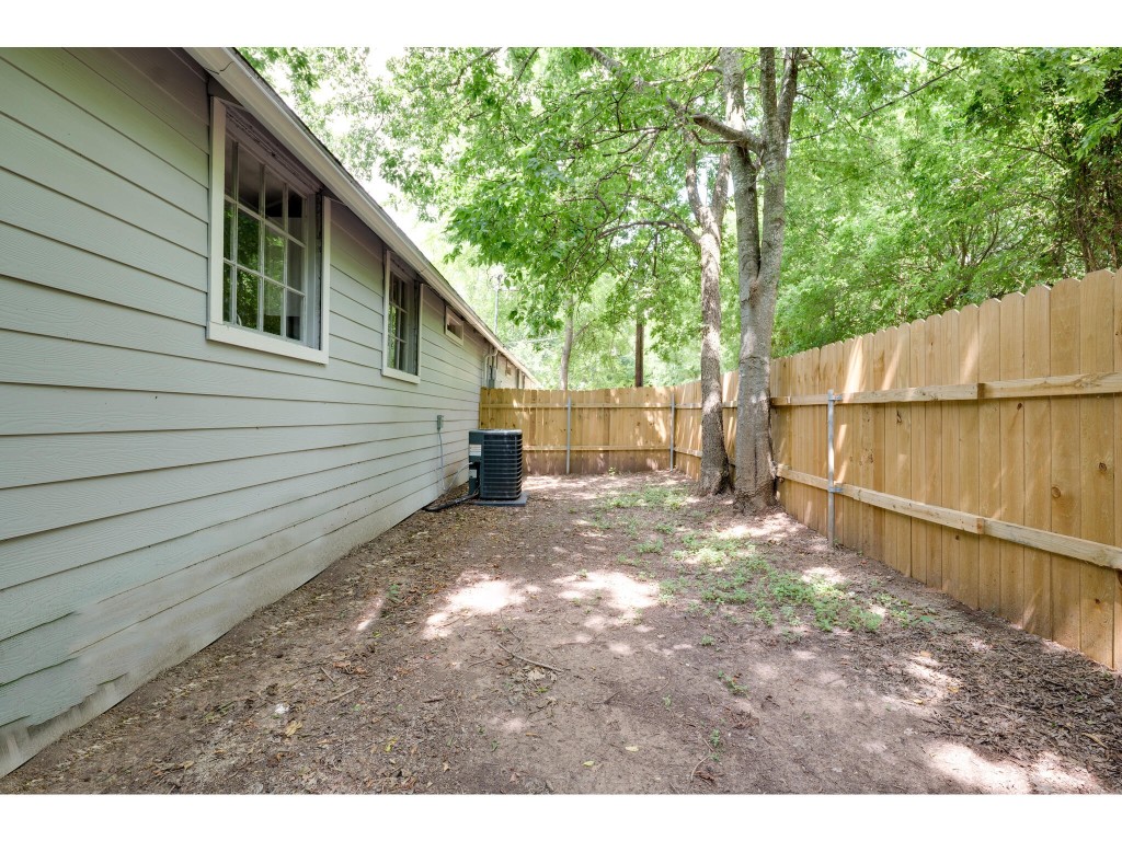 106 South Ave A, Unit E Elgin, TX 78621 - Photo 11 of 30 a view of a backyard with a large tree