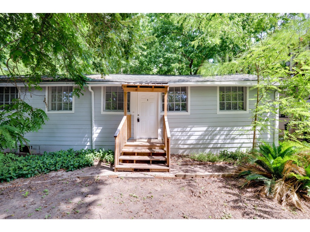 106 South Ave A, Unit E Elgin, TX 78621 - Photo 13 of 30 a backyard of a house with a garden and outdoor seating