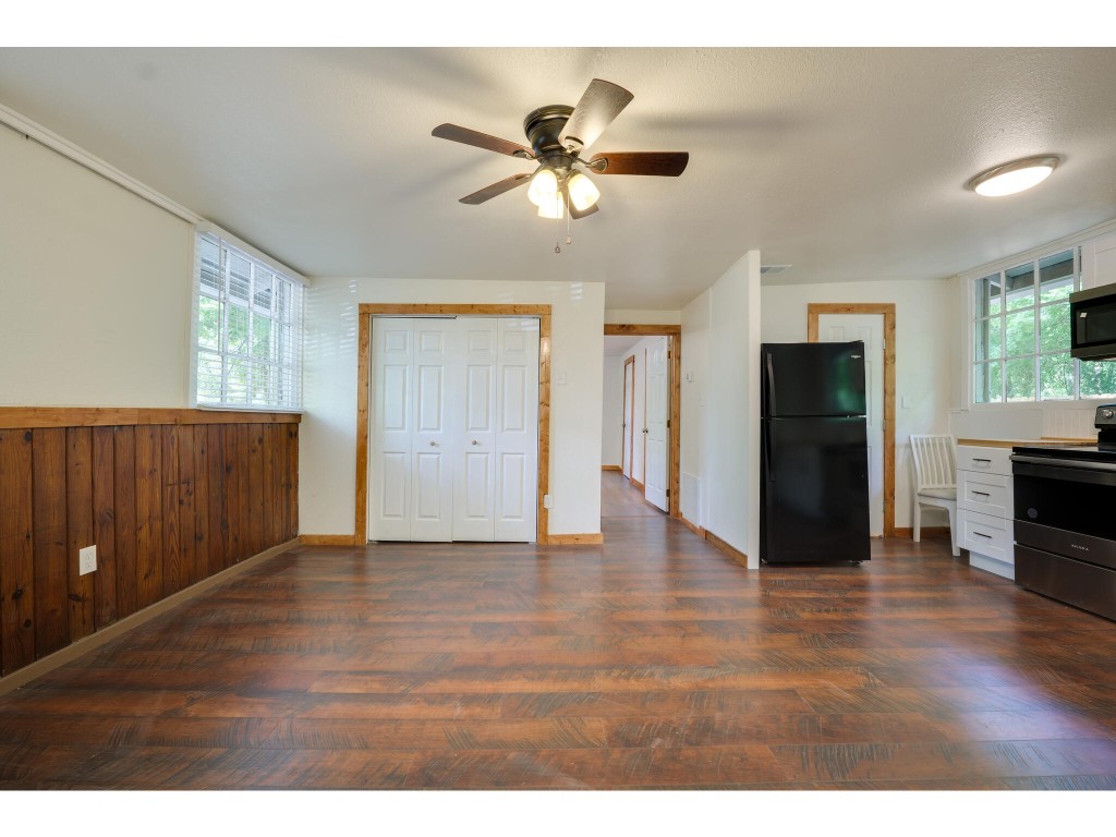 106 South Ave A, Unit E Elgin, TX 78621 - Photo 15 of 30 a view of an empty room with wooden floor and a window