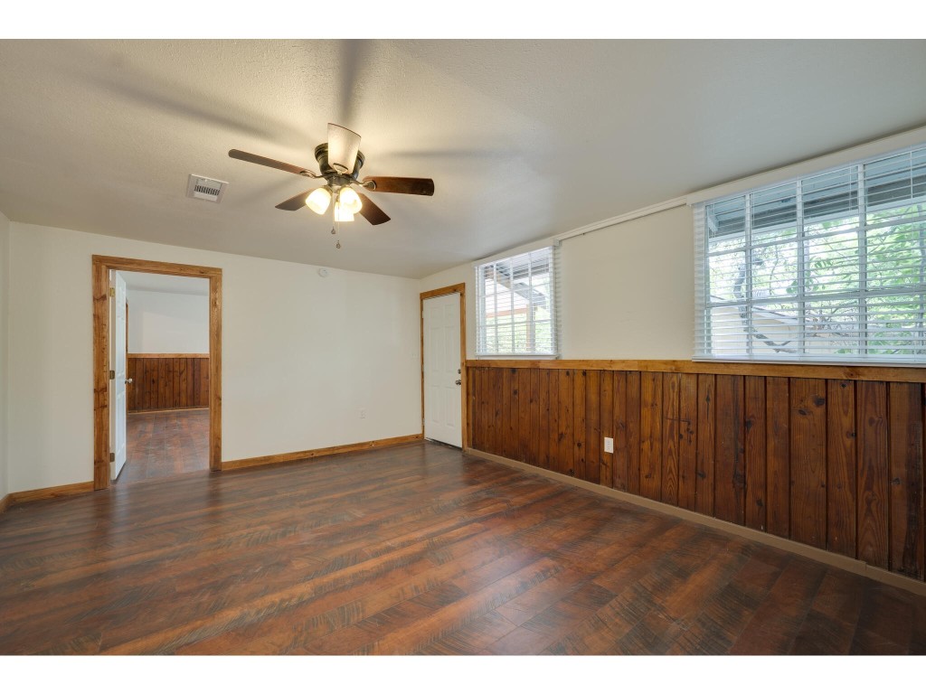 106 South Ave A, Unit E Elgin, TX 78621 - Photo 18 of 30 a view of an empty room with a window and wooden floor