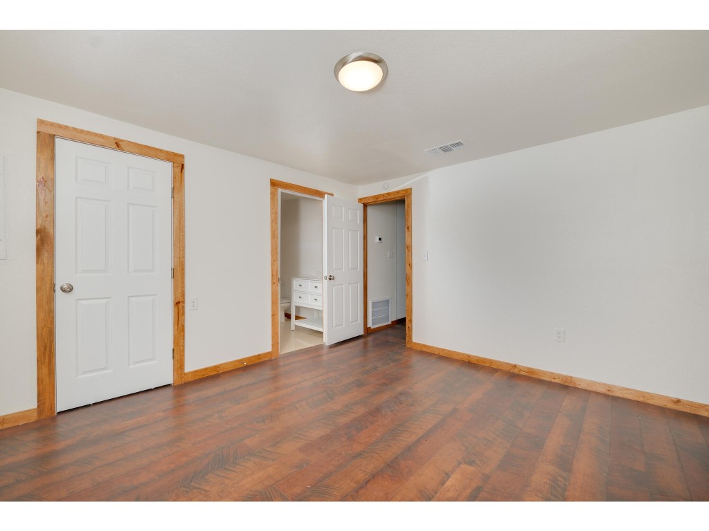 106 South Ave A, Unit E Elgin, TX 78621 - Photo 24 of 30 a view of an empty room with wooden floor
