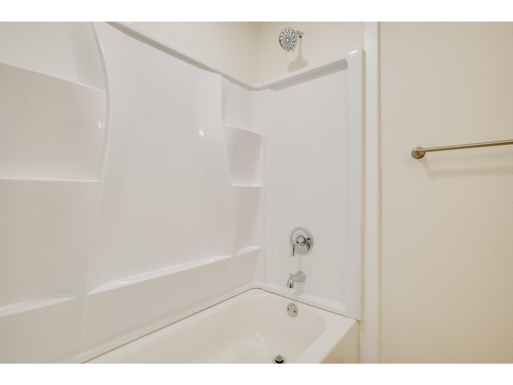 106 South Ave A, Unit E Elgin, TX 78621 - Photo 26 of 30 a bathroom with a bathtub and a shower