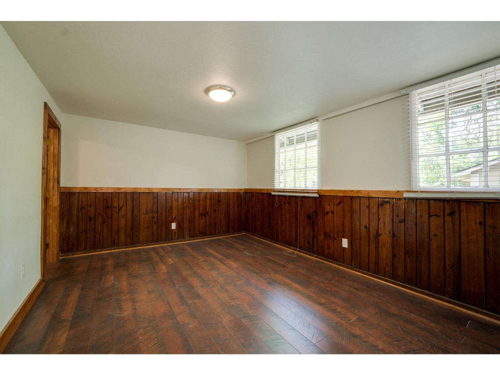 106 South Ave A, Unit E Elgin, TX 78621 - Photo 28 of 30 a view of an empty room with wooden floor and a window