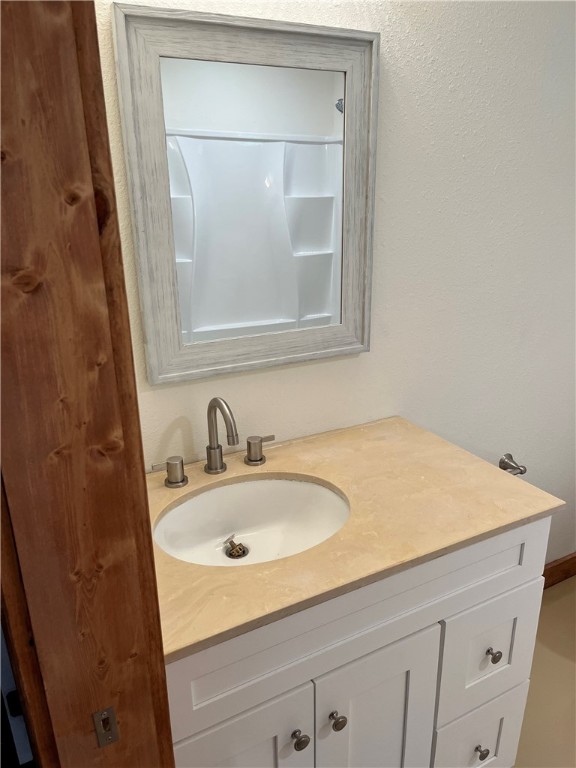 106 South Ave A, Unit E Elgin, TX 78621 - Photo 3 of 30 a bathroom with a sink and a white cabinet