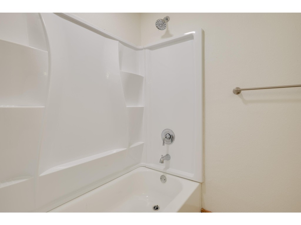 106 South Ave A, Unit E Elgin, TX 78621 - Photo 9 of 30 a bathroom with a bathtub and a shower