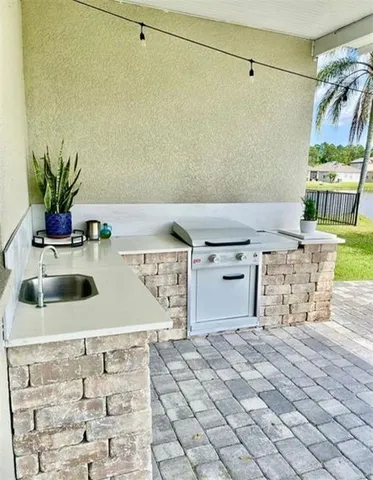 a kitchen with a stove a sink and a cabinets