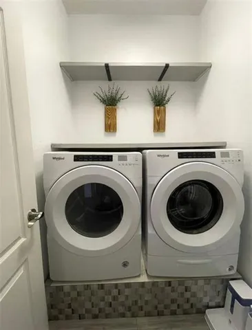 a bedroom with a large bed and a flat screen tv
