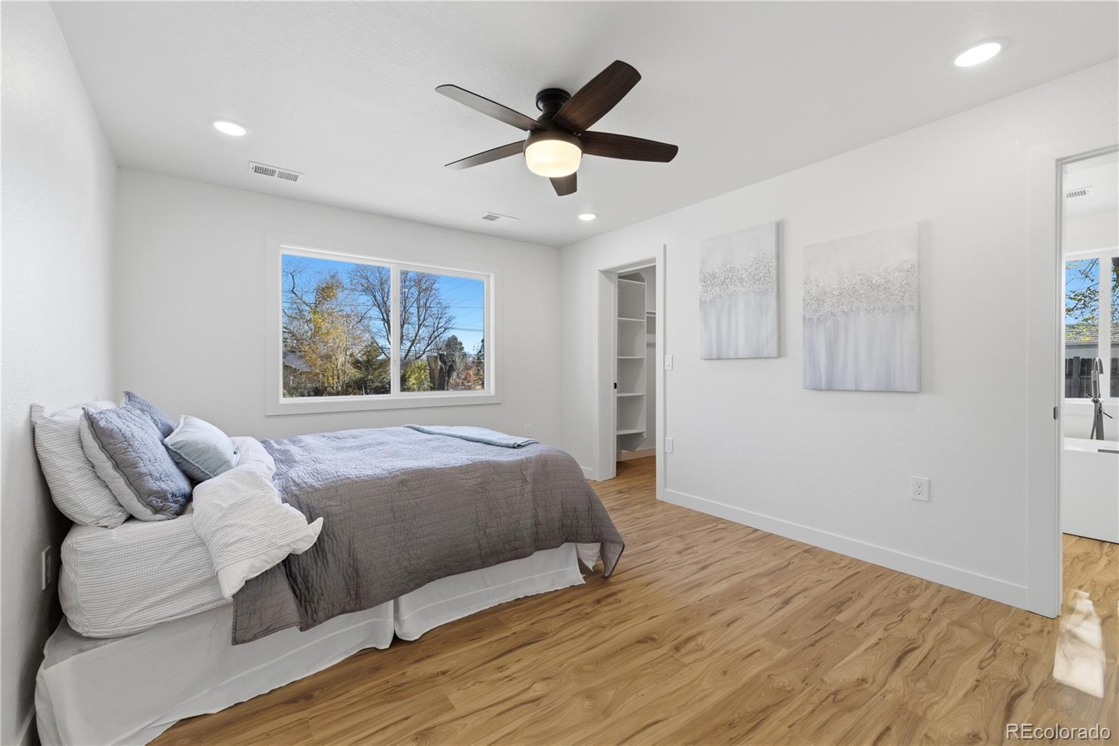 901 Garrison Street Lakewood, CO 80215 - Photo 11 of 47 a bedroom with a bed and window